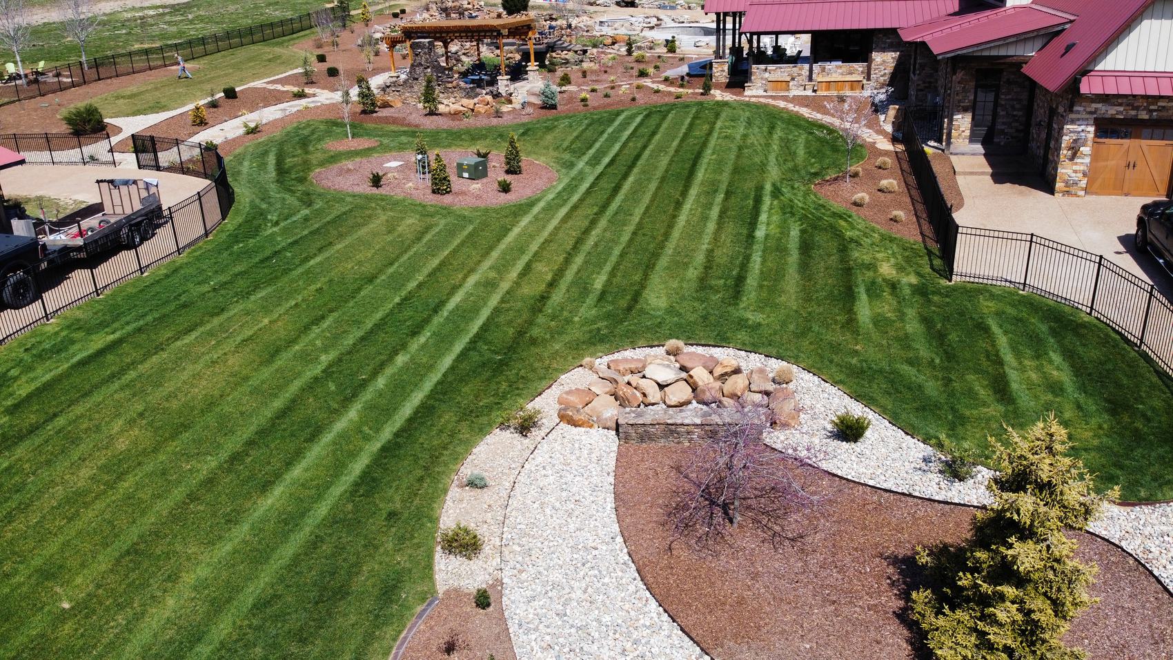 Finished grounds with stone bed and water feature